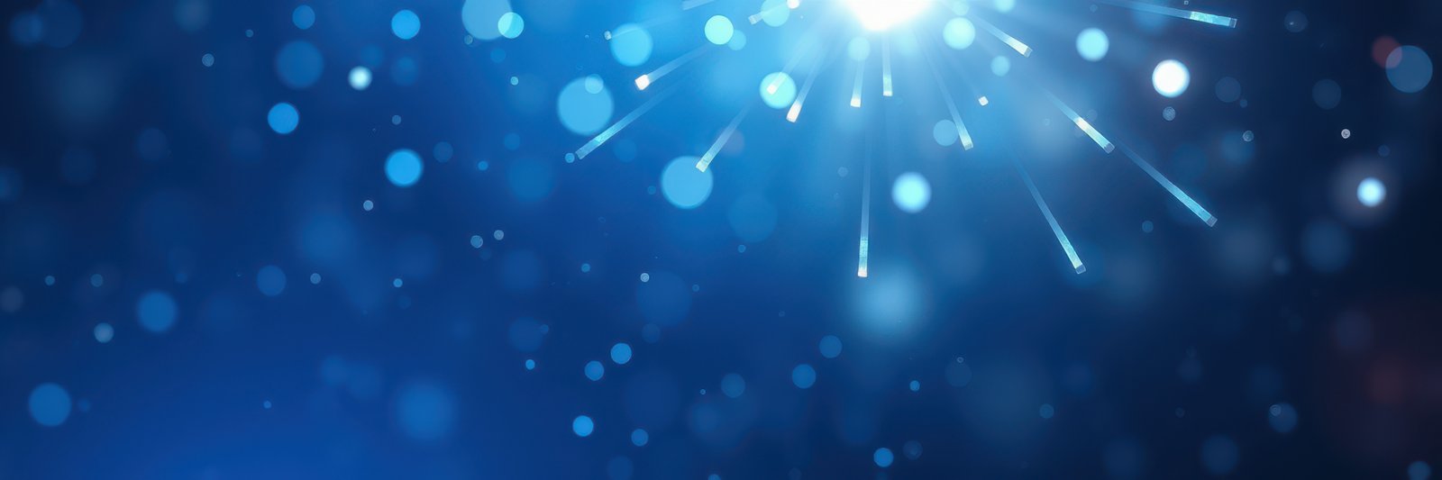 Bright light rays and shimmering blue bokeh create a captivating atmosphere for celebrations or events during the night